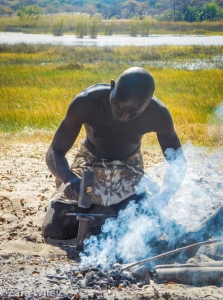 Mbunza man blacksmithing