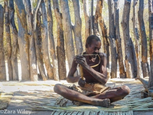 Mbunza man playing the instrument he made